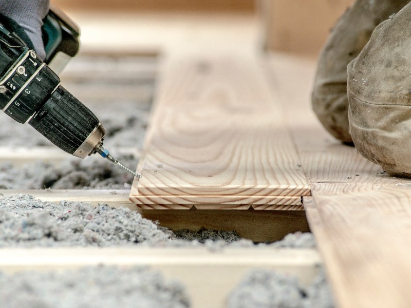 Eine Zellulose-Einblasdämmung isoliert von unten bevor der Fußboden verlegt wird